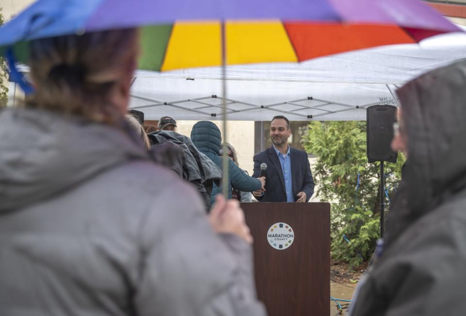 Marathon County Administrator Lance Leonhard takes the microphone to start speeches under a small tent outside the Marathon County Courthouse on Thursday for the Marathon County Social Services' Hands Around the Courthouse observance acknowledging April as Strengthening Families Month. The event featured speakers such as Marathon County Director of Social Services Christa Jensen and Marathon County Sheriff Chad Billeb.