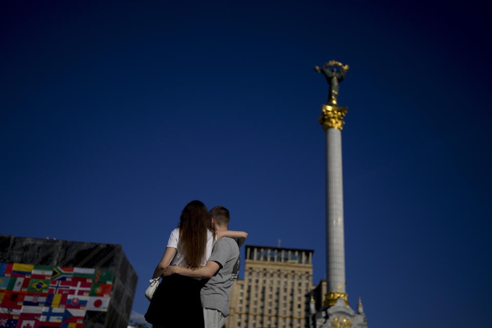 A couple embrace on Maidan square in Kyiv, Ukraine, Monday, June 6, 2022. (AP Photo/Natacha Pisarenko)