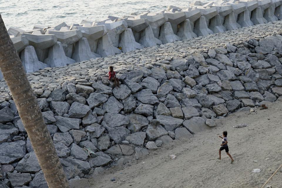 Kids play on a newly build sea wall in Kochi, Kerala state, India, March 4, 2023. Tens of millions of people in India live along coastlines and thus are exposed to major weather events. One common adaptation technique, in India and other countries hit hard by rising seas and oceanic storms, is to build sea walls. (AP Photo)