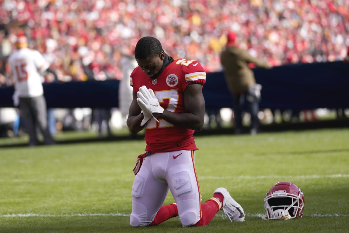 Kansas City Chiefs cornerback Rashad Fenton kneels on the field before the AFC championship NFL football game against the Cincinnati Bengals, Sunday, Jan. 30, 2022, in Kansas City, Mo. Public display of faith is nothing new in football or sports.(AP Photo/Paul Sancya, File)