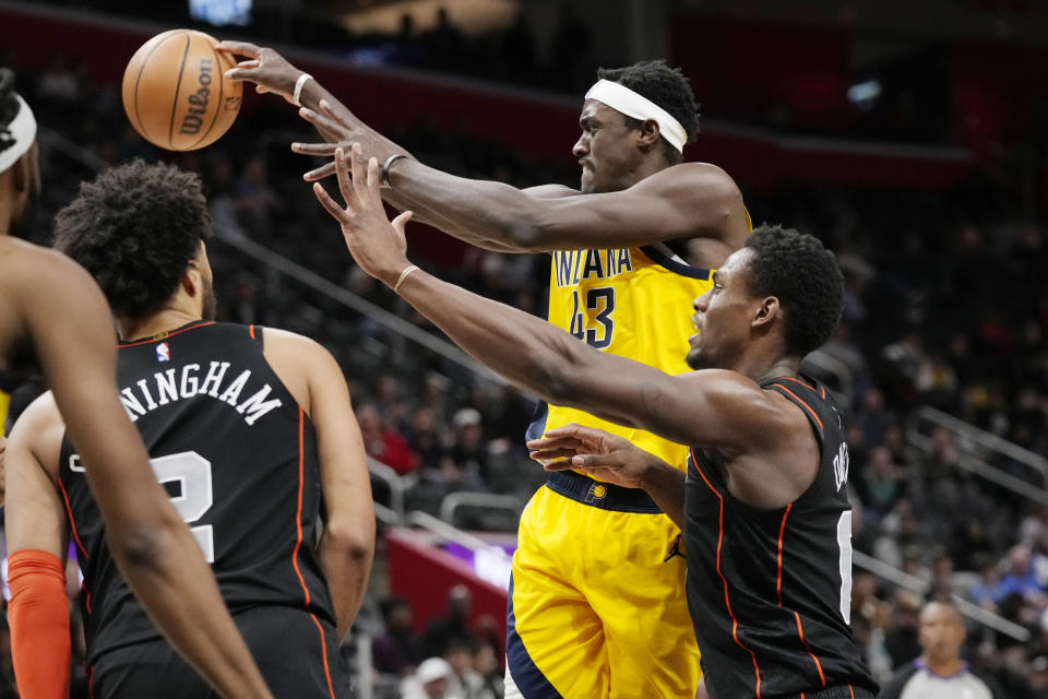Indiana Pacers forward Pascal Siakam (43) passes as Detroit Pistons center Jalen Duren (0) defends during the first half of an NBA basketball game, Wednesday, March 20, 2024, in Detroit. (AP Photo/Carlos Osorio)
