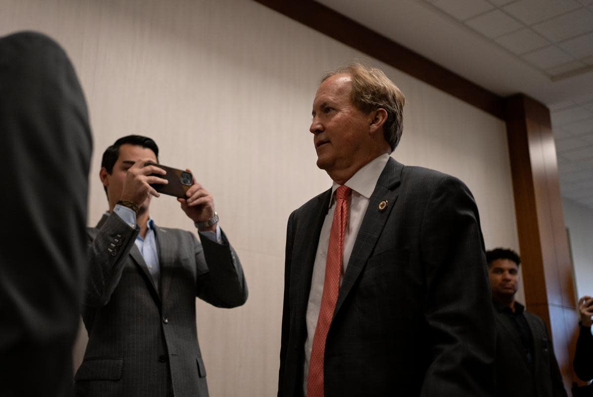 Texas Attorney General Ken Paxton enters the 185th Criminal District court at the Harris County Criminal Justice Center for a pretrial hearing in his securities fraud case on March 26, 2024, in Houston.