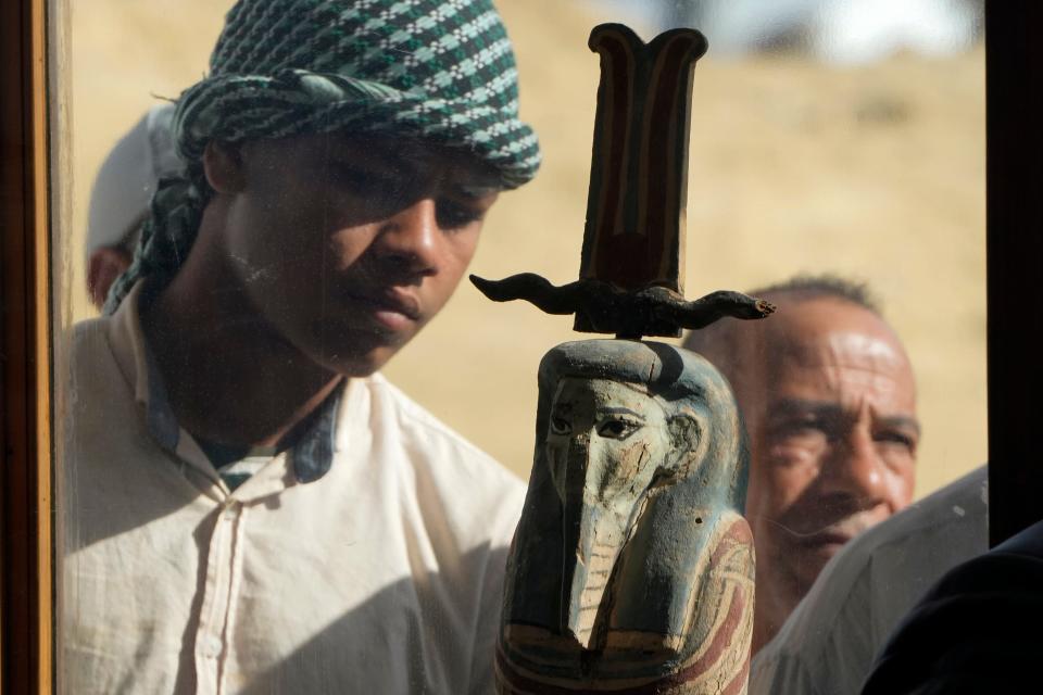 An Egyptian antiquities worker watches a recently discovered artifact at the site of the Step Pyramid of Djoser in Saqqara, 24 kilometers (15 miles) southwest of Cairo on Thursday.