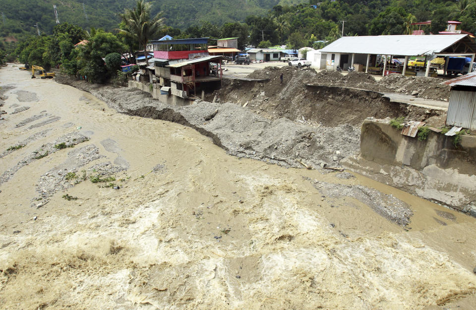A collapsed retaining wall sits along the banks of a flooded river in Dili, East Timor, Tuesday, April 6, 2021. Several disasters brought on by severe weather in eastern Indonesia and neighboring East Timor have left a number of people dead or missing. (AP Photo/Kandhi Barnez)