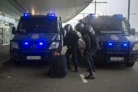 In this Monday, Oct. 14, 2019 photo, Spanish police clash with a pro-independence protester during a demonstration at El Prat airport, outskirts of Barcelona, Spain. Riot police engaged in a running battle with angry protesters outside Barcelona's airport Monday after Spain's Supreme Court convicted 12 separatist leaders of illegally promoting the wealthy Catalonia region's independence and sentenced nine of them to prison. (AP Photo/Joan Mateu)