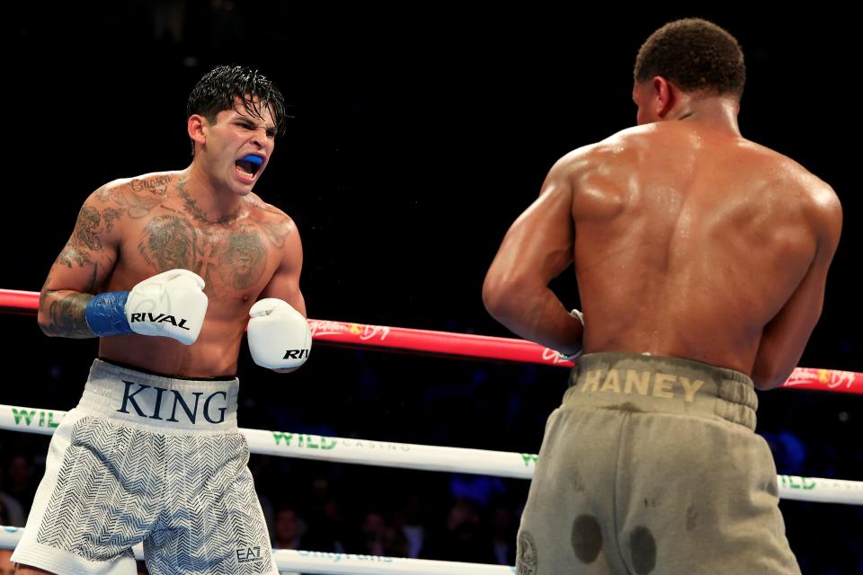 Ryan Garcia (left) reacts during his fight against Devin Haney (gray trunks) at Barclays Center on April 20, 2024,