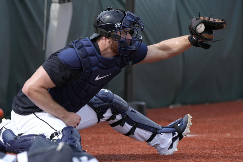 Detroit Tigers catcher Carson Kelly catches a pitch in the bullpen during a baseball spring training workout Friday, Feb. 16, 2024, in Lakeland, Fla. (AP Photo/Charlie Neibergall)