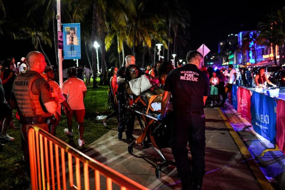 Miami Beach Fire Rescue transport a woman on a stretcher on Ocean Drive in Miami Beach, Florida on March 17, 2022.
