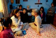 Lina Svenzen, a certified mid-wife from Sweden, talks with Irma Aranciba, who gave birth at home amidst the coronavirus disease (COVID-19) outbreak, as her other children look on, in La Paz