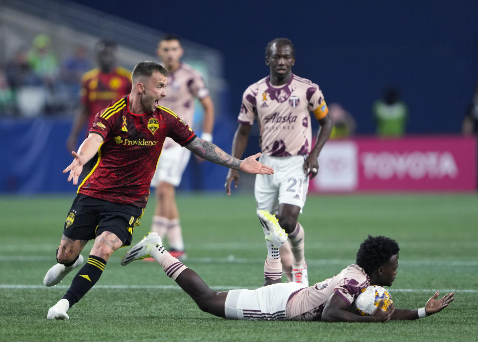 Seattle Sounders midfielder Albert Rusnák (11) reacts to being called for a foul against Portland Timbers midfielder Santiago Moreno, right, during the second half of an MLS soccer match Saturday, Sept. 2, 2023, in Seattle. The teams played to a 2-2 draw. (AP Photo/Lindsey Wasson)