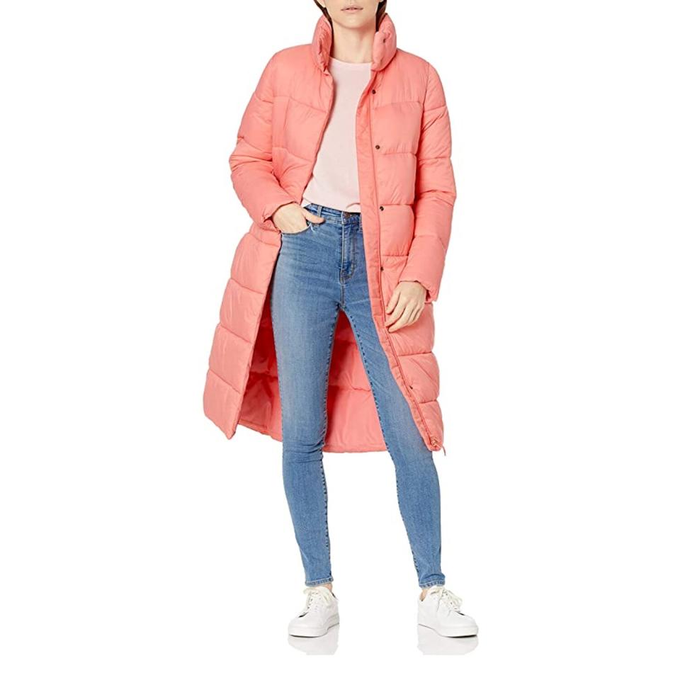 woman wearing long pink puffer coat with pink top, jeans and sneakers