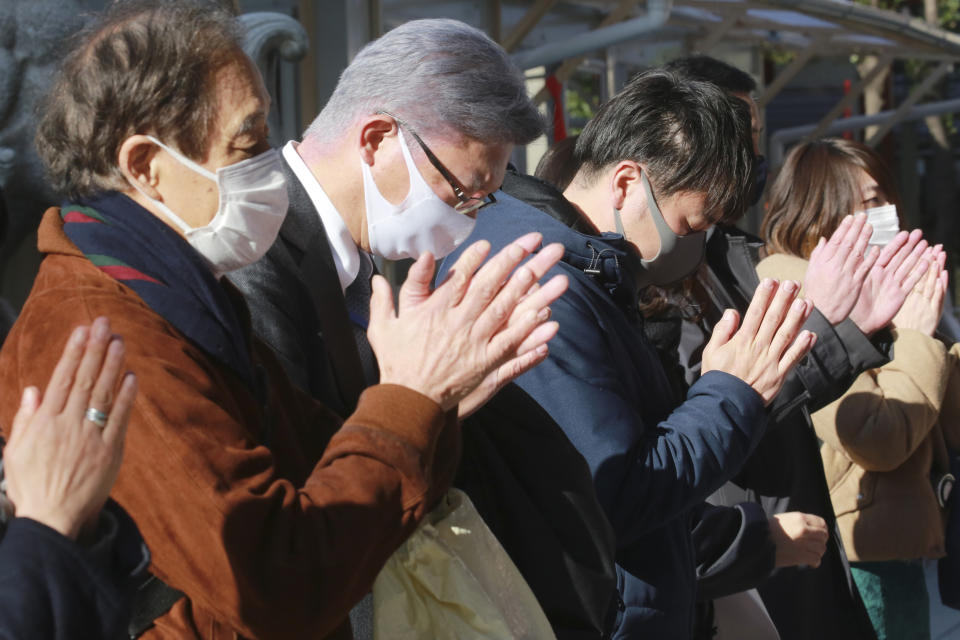 People wearing face masks to protect against the spread of the coronavirus offer prayers for New Year at the Kanda Myojin Shrine on the first business day of the year, in Tokyo, Monday, Jan. 4, 2021. Kanda Myojin is known as the shrine of commerce and industry. (AP Photo/Koji Sasahara)