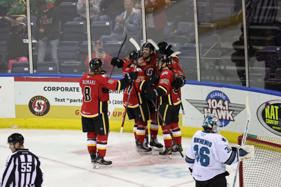 The Stockton Heat celebrates after scoring a goal during their April 2, 2022 home game against the San Jose Barracuda in Stockton at the Stockton Arena.