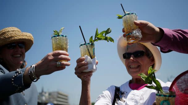 PHOTO: Racegoers who traveled to Churchill Downs from Colorado toast their mint julep bourbon cocktails while watching horse races on the eve of the Kentucky Derby in Louisville, Ky., May 1, 2015. (Bloomberg via Getty Images, FILE)