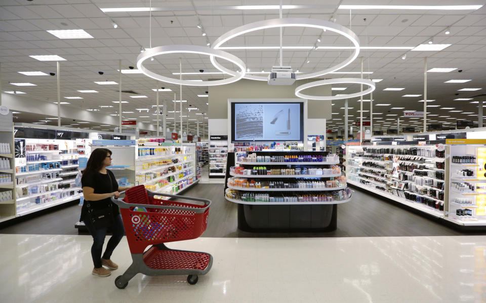 FILE- In this May 30, 2018, file photo, a shopper walks through the updated cosmetic department at a Target store in San Antonio. “There’s no doubt that, like others, we’re currently benefiting from a very strong consumer environment, perhaps the strongest I’ve seen in my career,” Target CEO Brian Cornell told investors. Target saw sales at established stores post the strongest growth in 13 years. (AP Photo/Eric Gay, File)