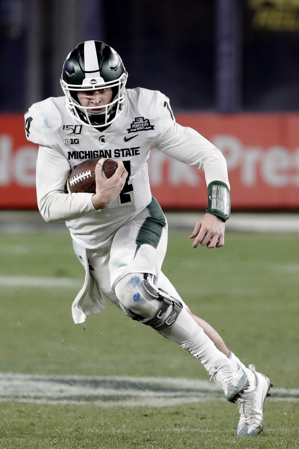 Michigan State quarterback Brian Lewerke (14) rushes during the second half of the Pinstripe Bowl NCAA college football game against Wake Forest, Friday, Dec. 27, 2019, in New York. (AP Photo/Frank Franklin II)