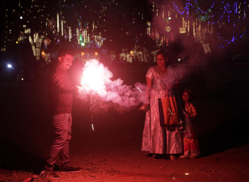 Indians light fire crackers as they celebrate Diwali, the festival of lights at a playground in Mumbai, India, Wednesday, Nov. 7, 2018. (AP Photo/Rajanish Kakade)