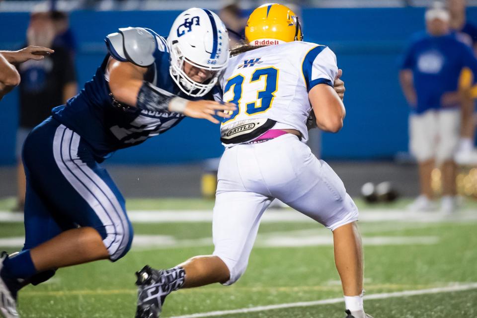 Spring Grove defensive lineman Michael Hershey drops Waynesboro's Brian Benedict (33) in the backfield for a loss of one yard during a non-league home game on Friday, August 26, 2022, in Jackson Township.