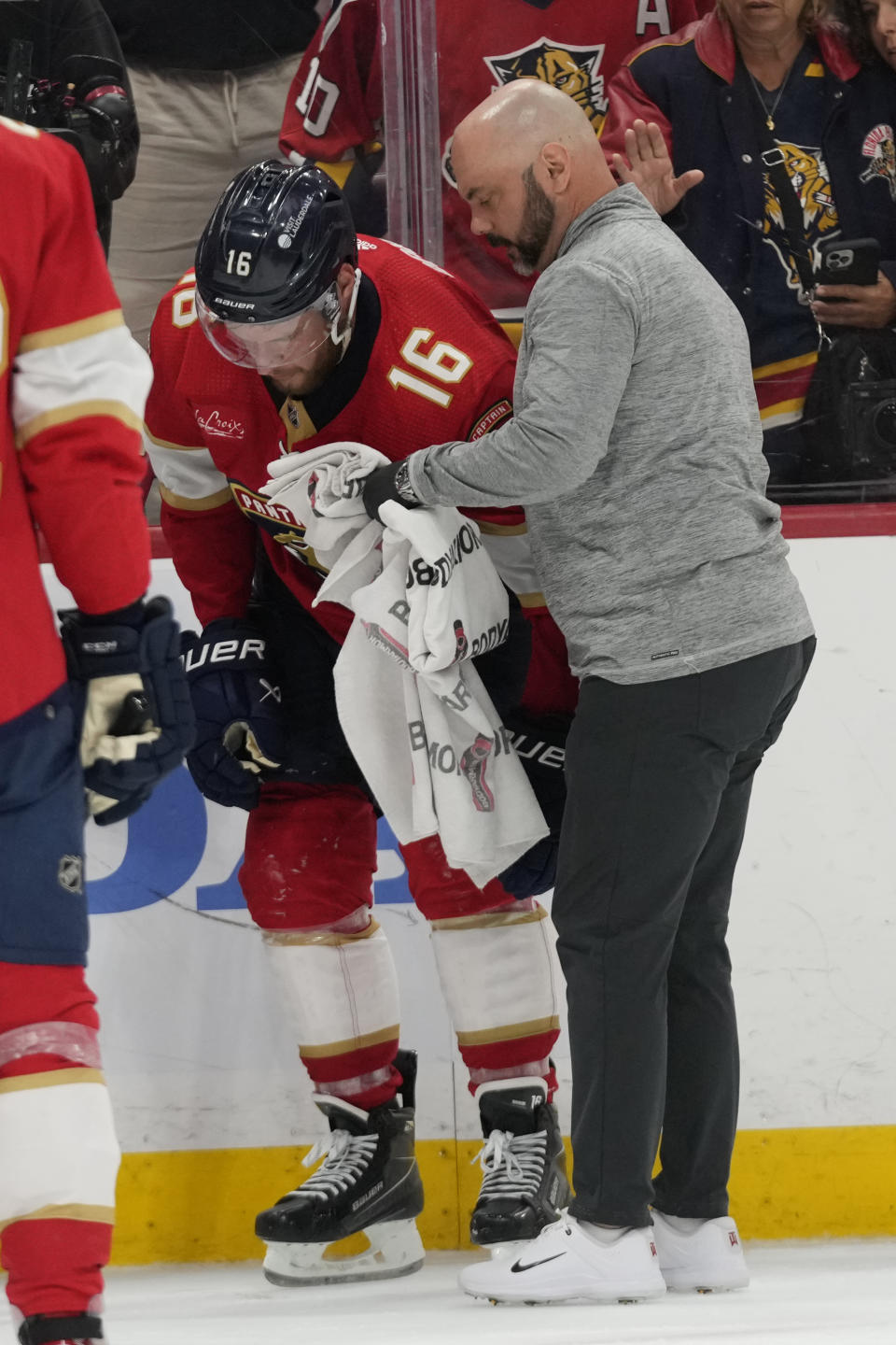 Florida Panthers center Aleksander Barkov (16) is assisted on the ice after he was injured during the third period of Game 2 of the NHL hockey Stanley Cup Finals against the Edmonton Oilers, Monday, June 10, 2024, in Sunrise, Fla. (AP Photo/Wilfredo Lee)