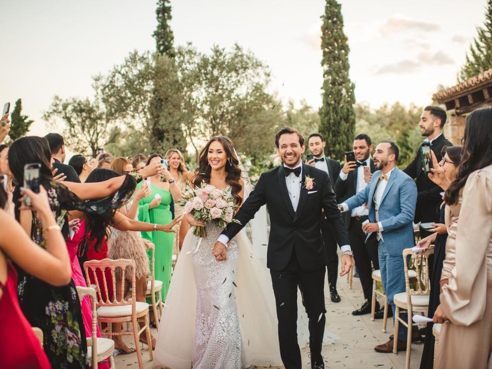 A bride and groom walk out of their wedding ceremony.