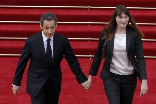 Former French president Nicolas Sarkozy and his wife Carla Bruni-Sarkozy leave the Elysee Palace in Paris. Socialist leader Francois Hollande has been sworn in as French president at a solemn ceremony overshadowed by the catastrophic debt crisis threatening to unravel the eurozone