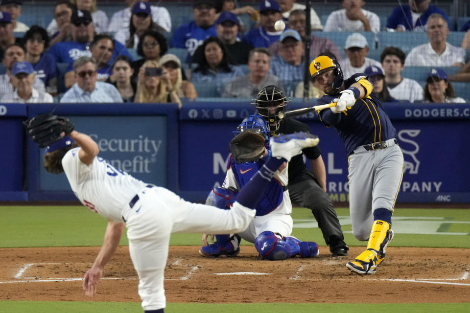 Milwaukee Brewers' Rhys Hoskins, right, hits a grand slam as Los Angeles Dodgers starting pitcher Tyler Glasnow, left, and catcher Will Smith, second from left, watch along with home plate umpire Brian Walsh during the fourth inning of a baseball game Friday, July 5, 2024, in Los Angeles. (AP Photo/Mark J. Terrill)