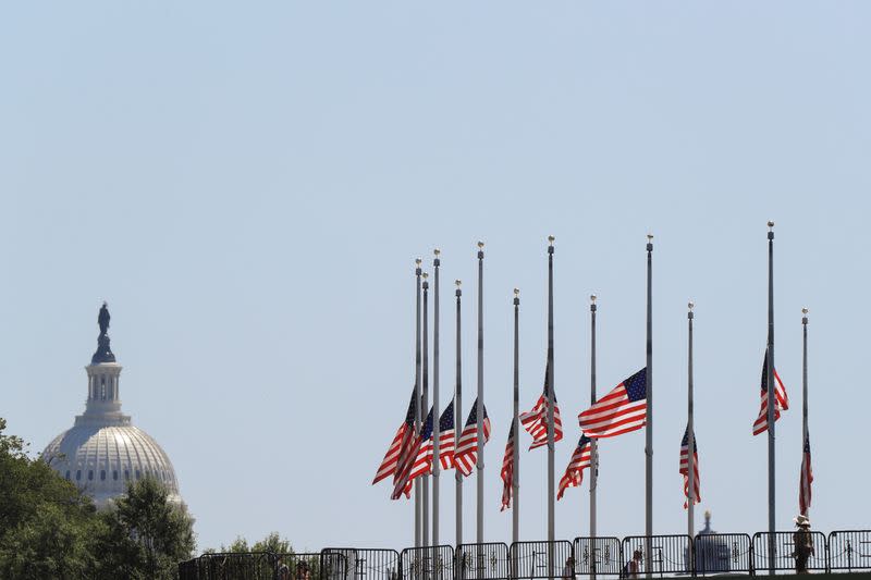 Flags surrounding the Washington Monument are lowered to half-staff following the death of Congressman John Lewis, on the National Mall in Washington