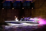 LONDON, ENGLAND - JULY 27: David Beckham passes under Tower Bridge driving a speedboat named 'Max Power' which carries the Olympic Torch with its torchbearer on July 27, 2012 in London, England. Athletes, heads of state and dignitaries from around the world have gathered in the Olympic Stadium for the opening ceremony of the 30th Olympiad. London plays host to the 2012 Olympic Games which will see 26 sports contested by 10,500 athletes over 17 days of competition. (Photo by Matthew Lloyd/Getty Images)