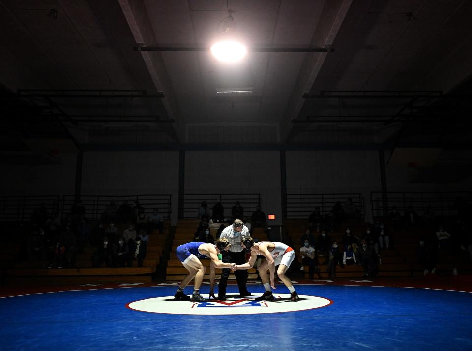 Ashland's Liam Fleming (left) and Wayland's Colby Hanlon shake hands before their 160 lbs. bout at Ashland Middle School, Jan. 13, 2021.