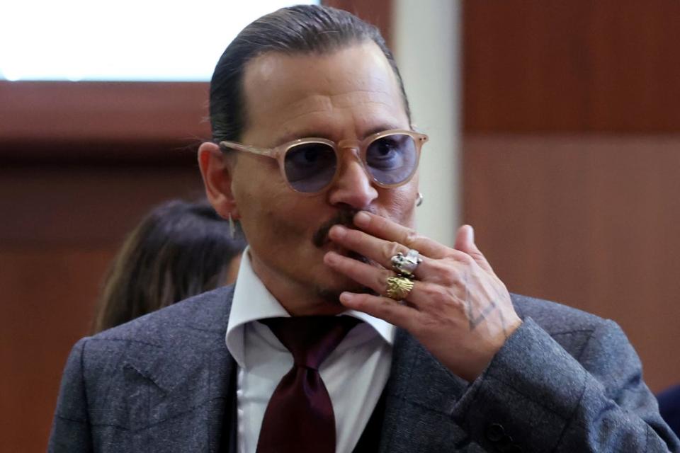 Actor Johnny Depp reacts to fans in the courtroom on Thursday (AP)