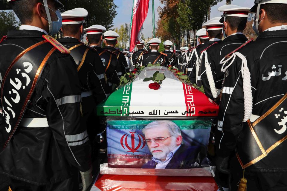 In this photo released by the official website of the Iranian Defense Ministry, military personnel stand near the flag-draped coffin of Mohsen Fakhrizadeh, a scientist who was killed on Friday, during a funeral ceremony in Tehran, Iran, Monday, Nov. 30, 2020.