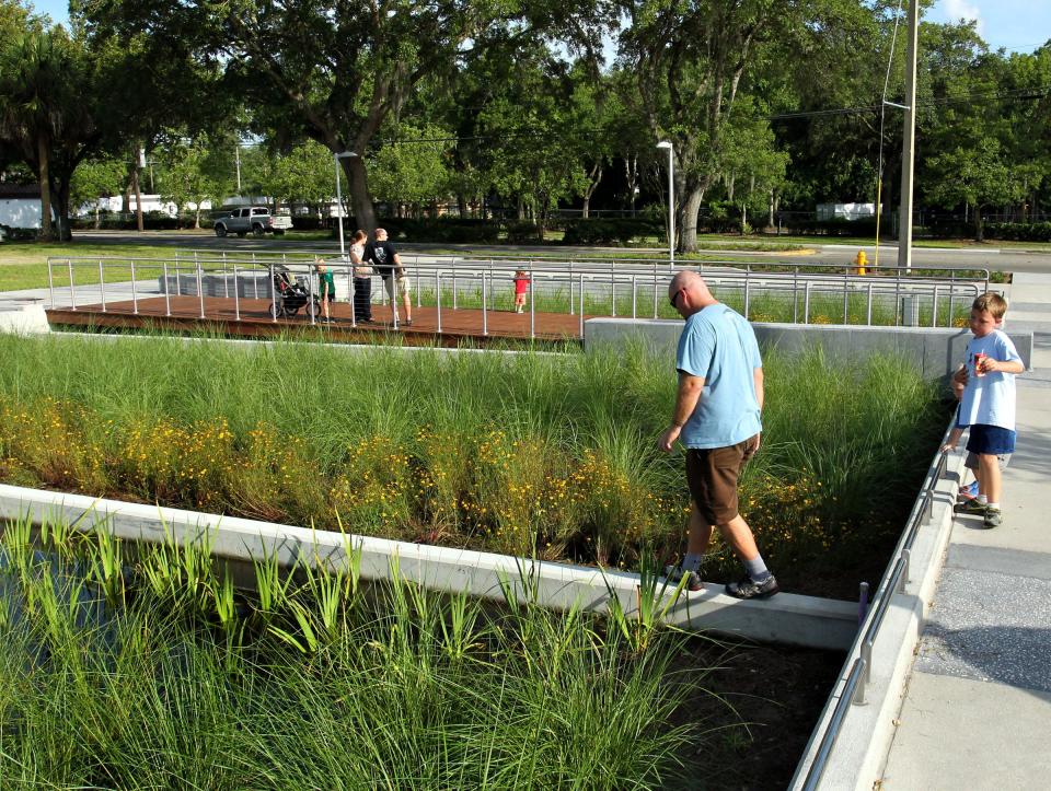 Residents explore the park and roadways in Innovation Square during an event celebrating their opening in 2014.