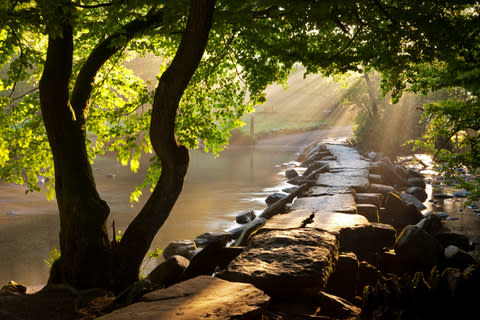 The Tarr Steps crosses the River Barle on seventeen arches - Credit: getty