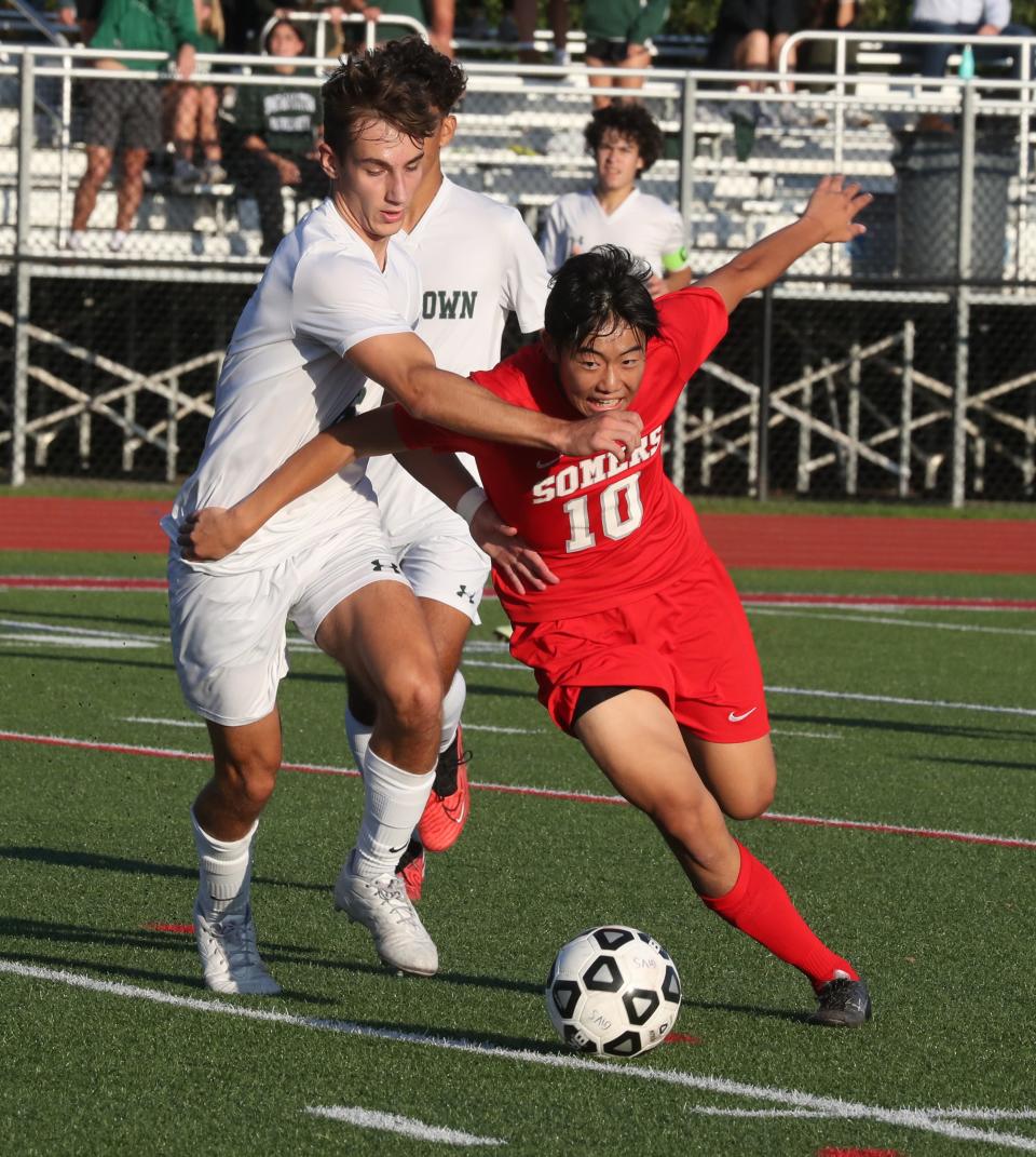 Yorktown's Joseph Granitto, left, fights for the ball with Somers' Hyugo Todo during their game at Somers Sept. 27, 2023. Somers won 2-1.