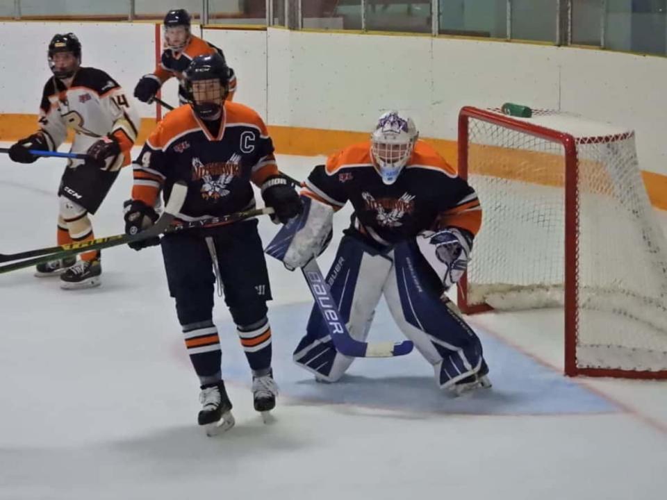 The Beaver Valley Nitehawks, in orange and blue, are pictured playing against the Castlegar Rebels in a Kootenay International Junior Hockey League regular season game on Oct. 15. (Beaver Valley Nitehawks/Facebook - image credit)