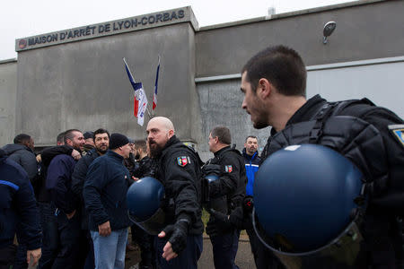Prison wardens are surrounded by French gendarmes as they block the Lyon-Corbas jail near Lyon during a nationwide protest, France, January 22, 2018. REUTERS/Emmanuel Foudrot