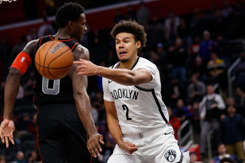 Nets forward Cameron Johnson passes past Pistons center Jalen Duren in the second half of the Pistons' 118-112 loss to the Nets on Tuesday, Dec. 26, 2023, at Little Caesars Arena.