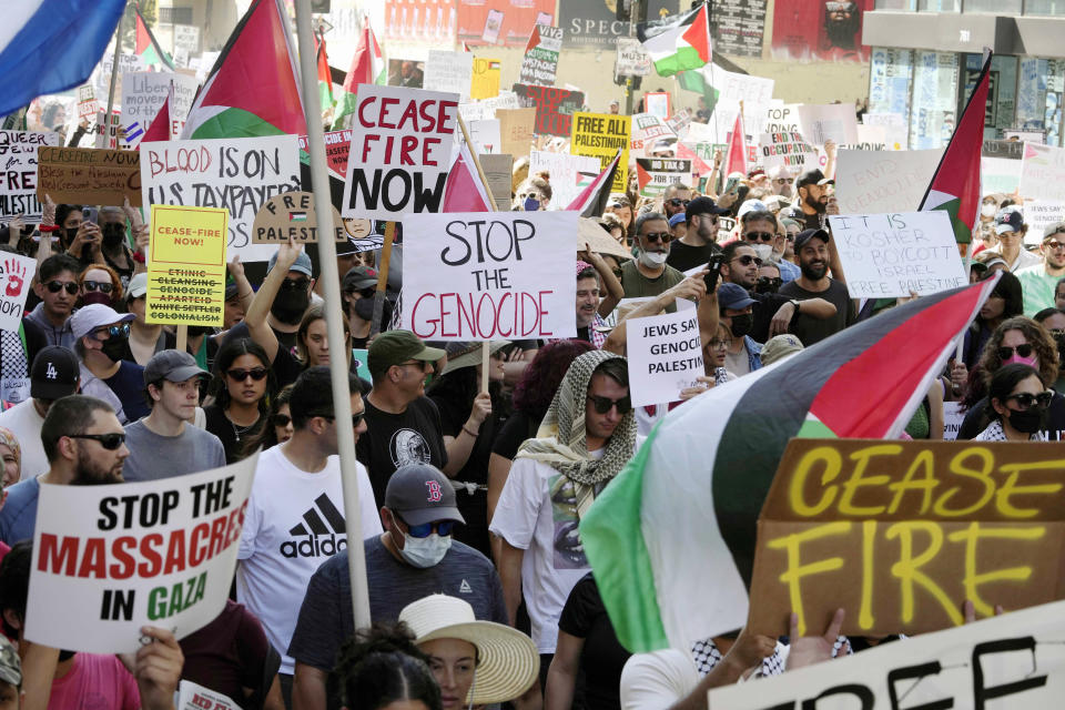 People participate during a pro-Palestinian march calling for a cease-fire in Gaza, Saturday, Oct. 21, 2023, downtown Los Angeles. (AP Photo/Damian Dovarganes)