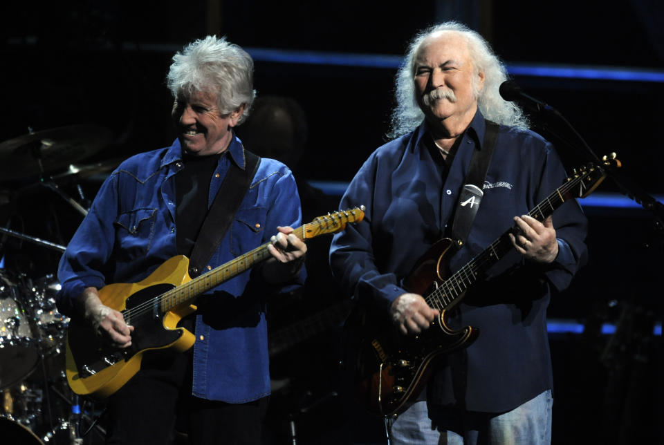 FILE - David Crosby, right, and Graham Nash perform at the 25th Anniversary Rock & Roll Hall of Fame concert at Madison Square Garden, Thursday, Oct. 29, 2009, in New York. Crosby, the brash rock musician who evolved from a baby-faced harmony singer with the Byrds to a mustachioed hippie superstar and an ongoing troubadour in Crosby, Stills, Nash & (sometimes) Young, has died at age 81. His death was reported Thursday, Jan. 19, 2023, by multiple outlets. (AP Photo/Henny Ray Abrams, File)