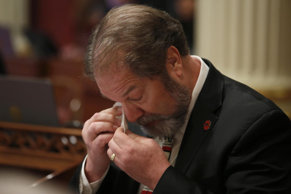 State Senate John Moorlach, R-Costa Mesa, wipes his eyes after giving an emotional speech where he recalled his developmentally disabled cousin who died at a your age, as he urged lawmakers to reject a companion measure to recently passed legislation to tighten the rules on giving exemptions for vaccinations, at the Capitol in Sacramento, Calif., Monday, Sept. 9, 2019. The measure was approved by both houses of the Legislature and signed by Gov.Gavin Newsom. (AP Photo/Rich Pedroncelli)
