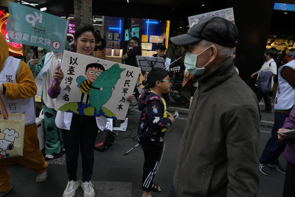 Supporters of Ko Wen-je, Taiwan People's Party (TPP) presidential candidate, canvass for votes in Taipei, Taiwan on Sunday, Jan. 7, 2024. With Taiwan's high-stakes presidential election just days away, the nonconformist candidate has been resonating with the island's youth, seemingly more concerned with the dearth of good jobs and affordable housing than the looming threat from China. (AP Photo/Ng Han Guan)