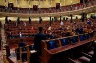 Spanish PM Sanchez and deputies stand up during a minute of silence at the start of a session on coronavirus disease (COVID-19) at Parliament in Madrid