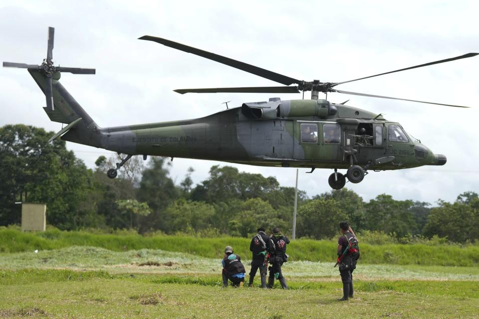 FILE - A military helicopter takes off with a group of Indigenous at a military base in Calamar, Colombia, May 23, 2023, to help search for four Indigenous children who went missing after a deadly plane crash. (AP Photo/Fernando Vergara, File)