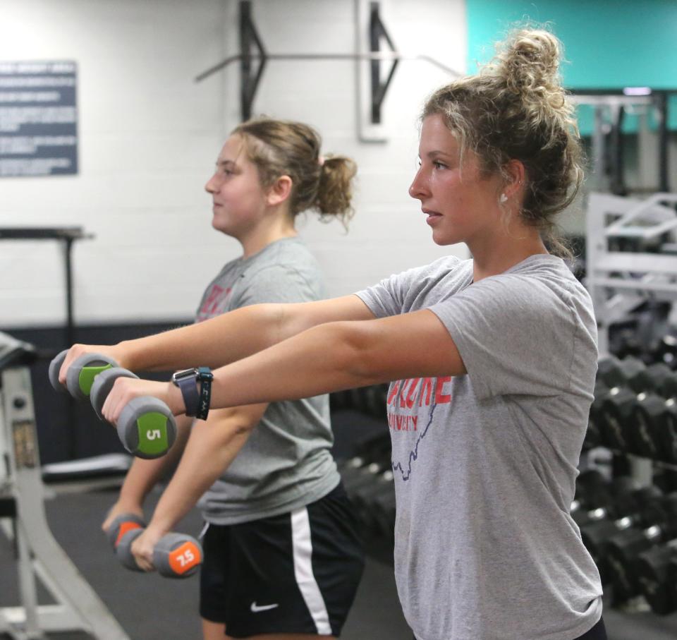 Sisters Morgan Rekstis, left, and Madison Rekstis, right, work out at the YMCA in North Canton on Wednesday, June 29, 2022. The facility reopened today after being closed for six days due to a pool leak.