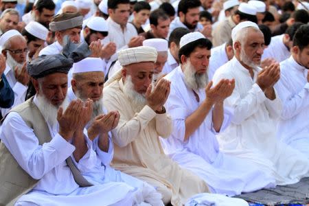 People attend Eid al-Fitr prayers to mark the end of the holy fasting month of Ramadan in a park in Peshawar, Pakistan June 25, 2017. REUTERS/ Fayaz Aziz