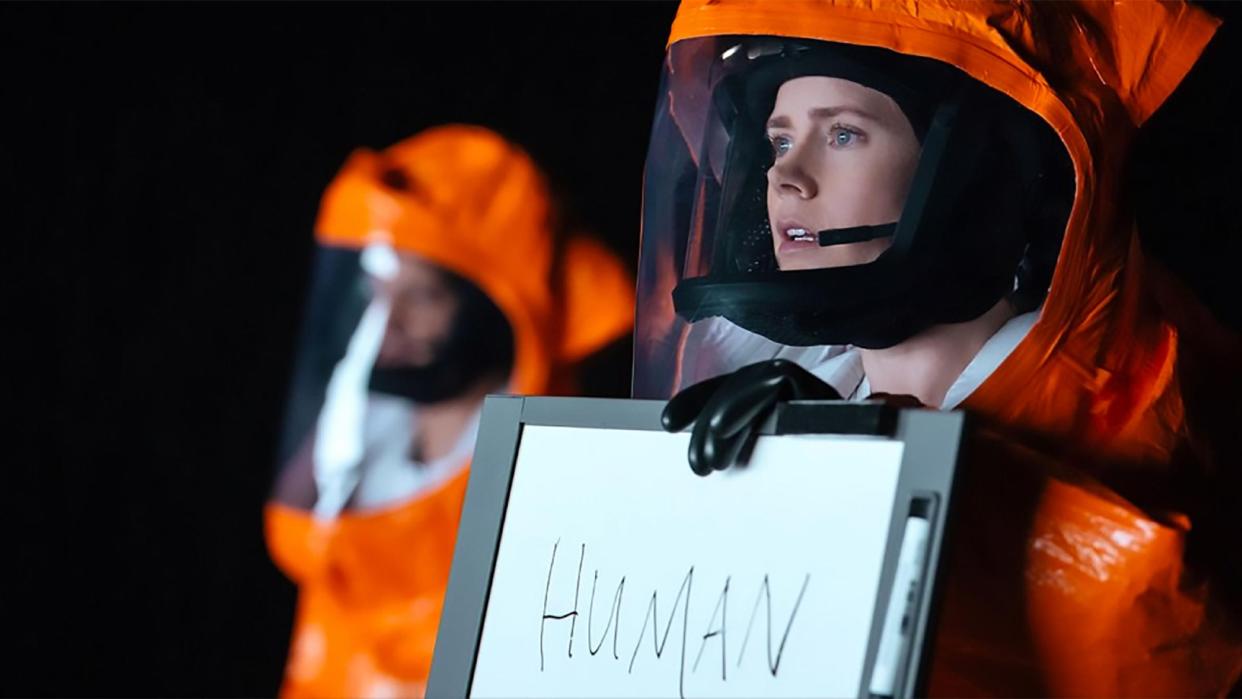  Amy Adams holds up a sign reading HUMAN in Arrival. 