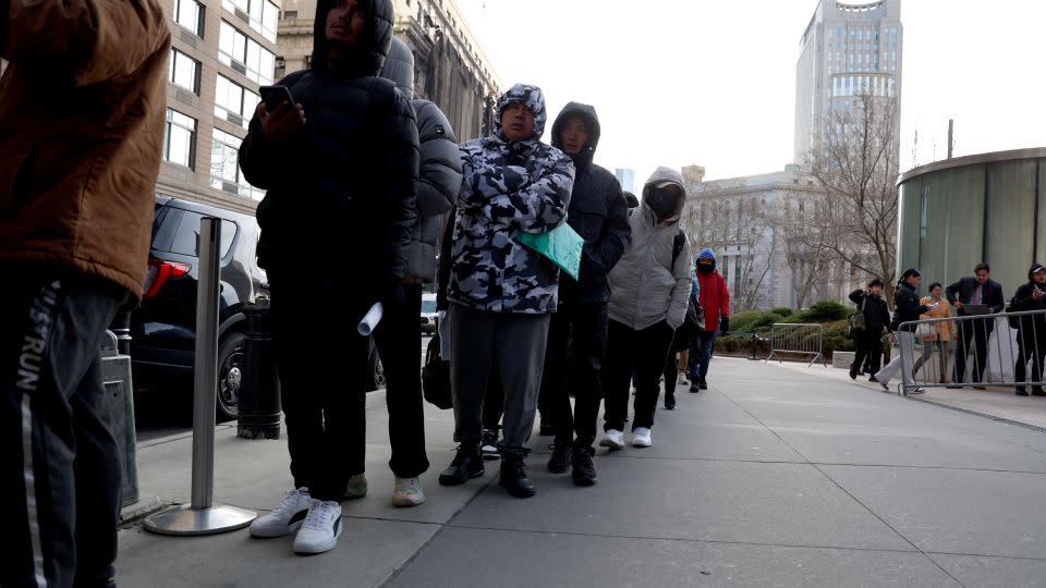 Migrants line up outside the Jacob Javits Federal Building in downtown Manhattan on December 5. - Luiz C. Ribeiro/NY Daily News/Getty Images
