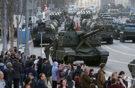 FILE PHOTO: People gather near Russian military vehicles in Tverskaya street before the rehearsal for the Victory Day parade in central Moscow, Russia, May 3, 2017. REUTERS/Sergei Karpukhin/File Photo