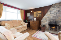 <p>While the bar is the main attraction, it offers plenty of other comforts, including a fireplace in the cozy lounge. (Airbnb) </p>