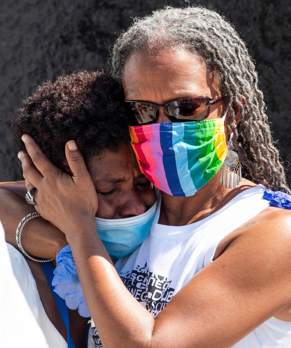 Tafeni English, left, and Lecia Brooks hug during the Juneteenth/Tulsa Riot Vigil held at the Civil Rights Memorial located at the Southern Poverty Law Center in Montgomery, Ala., on Friday June 19, 2020.